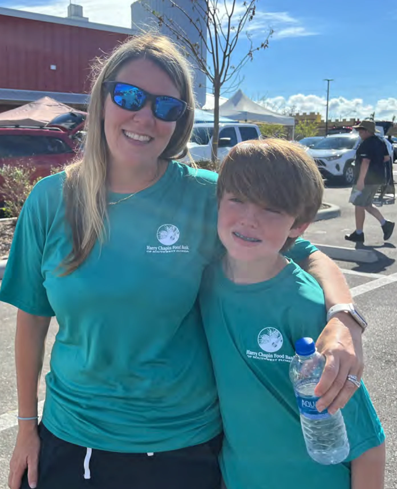 Volunteers wearing food-bank shirts at an event