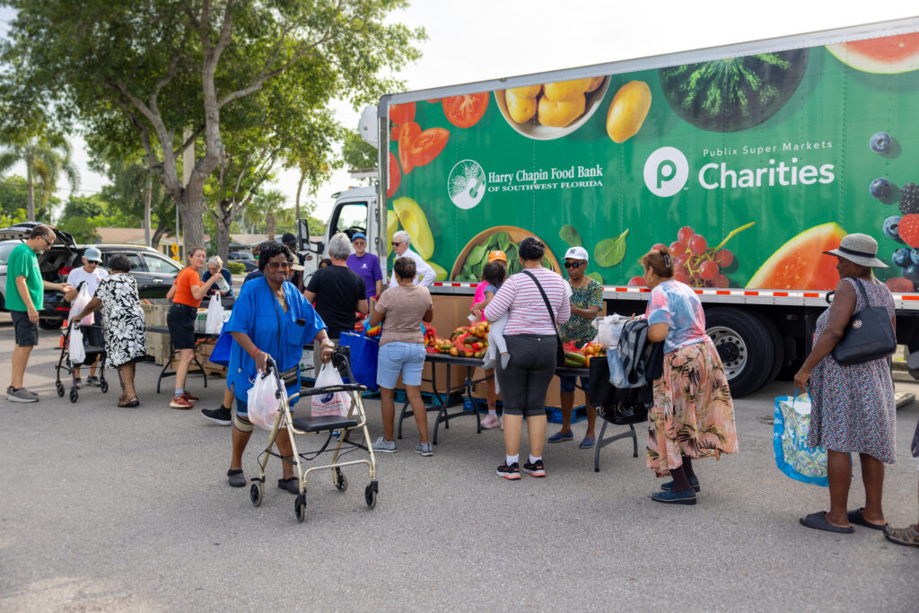 Neighbors gather at an HCFB mobile food distribution truck